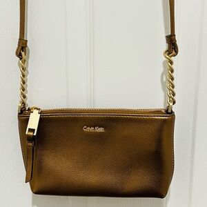Calvin Klein Crossbody Bag in a bronze color featuring gold-toned hardware
